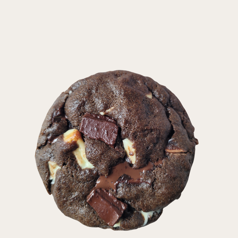 Triple Chocolate Chunk Cookie with dark, milk, and white Belgian chocolate chunks on a neutral beige background.